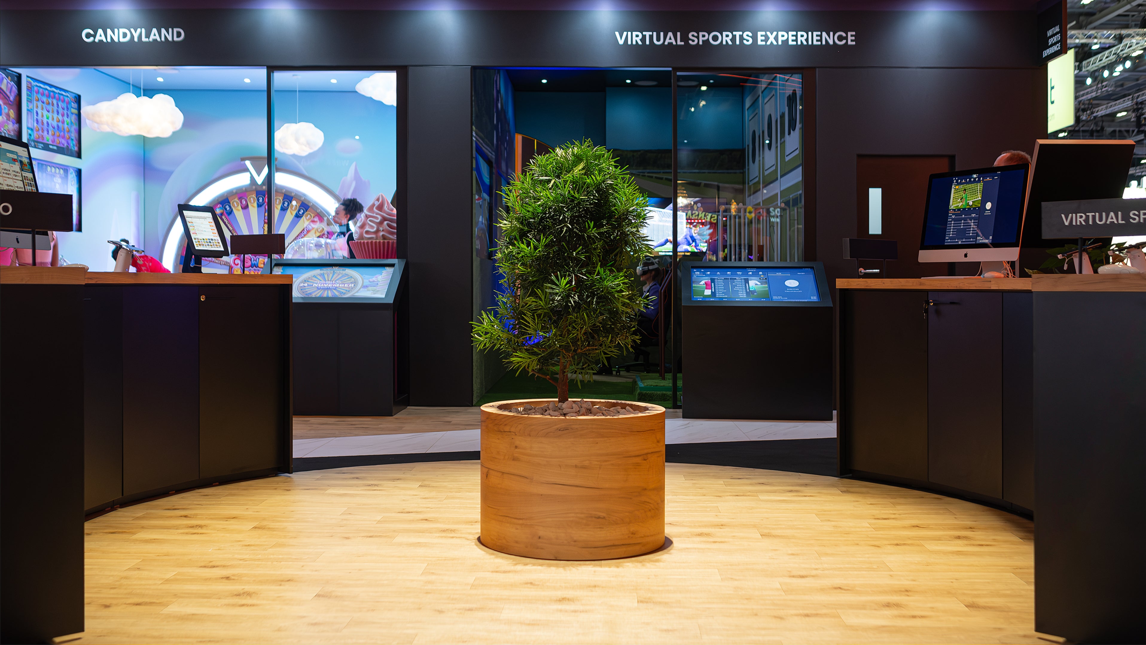 We proposed this robust, sculpted evergreen tree in a large wooden planter to provide a natural accent within the engaging Virtual Sports Experience zone at the ICE London Exhibition, bridging the gap between the digital and natural elements.