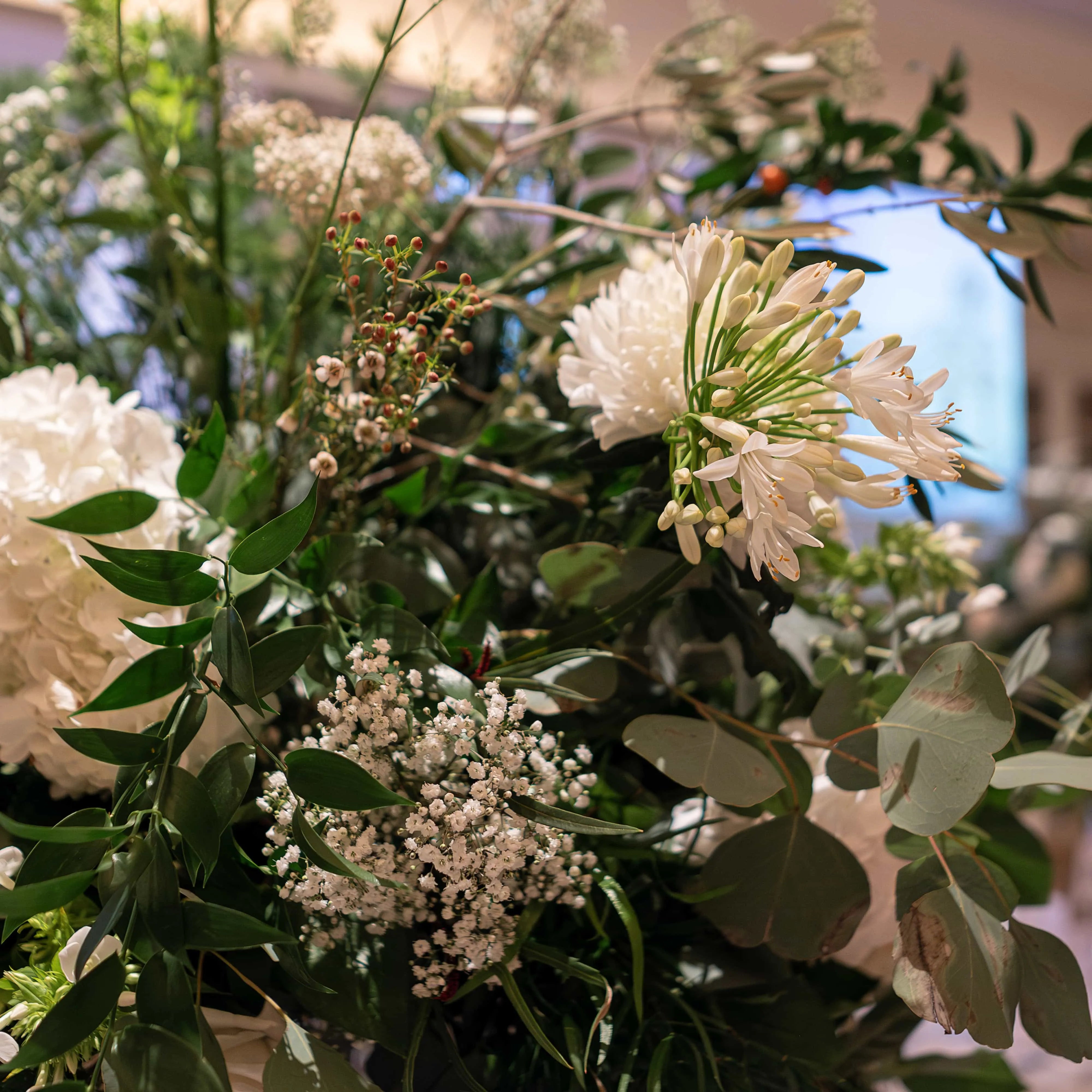  This is a close-up of one of our bespoke floral arrangements for his event. It is a luxurious mix of white blooms and lush greenery, exquisitely crafted for this corporate event. Amaranté London Flowers for Corporate Events - unparalleled attention to detail and elegance.