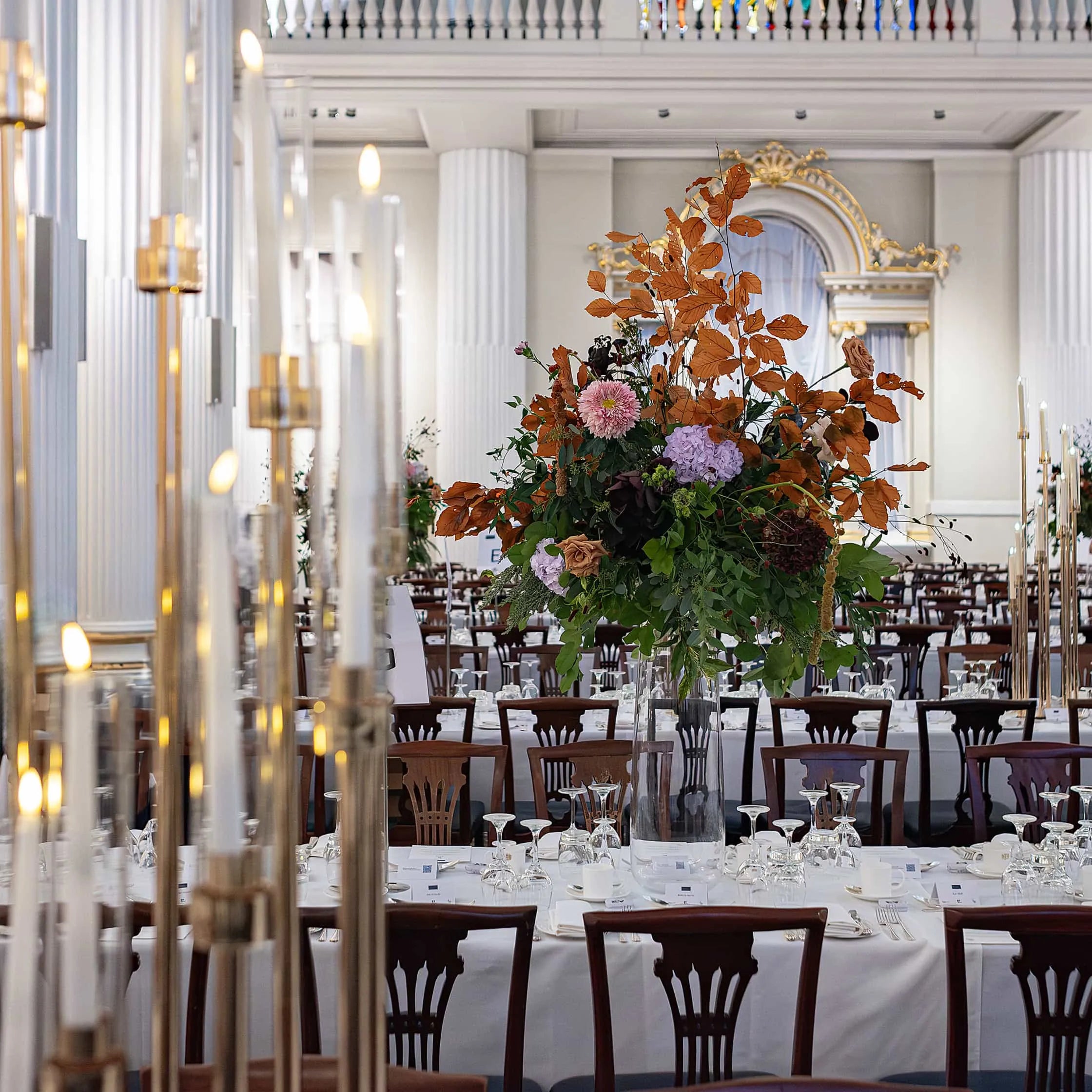 A grand, bespoke table centrepiece amidst a freshly set table - Amaranté London