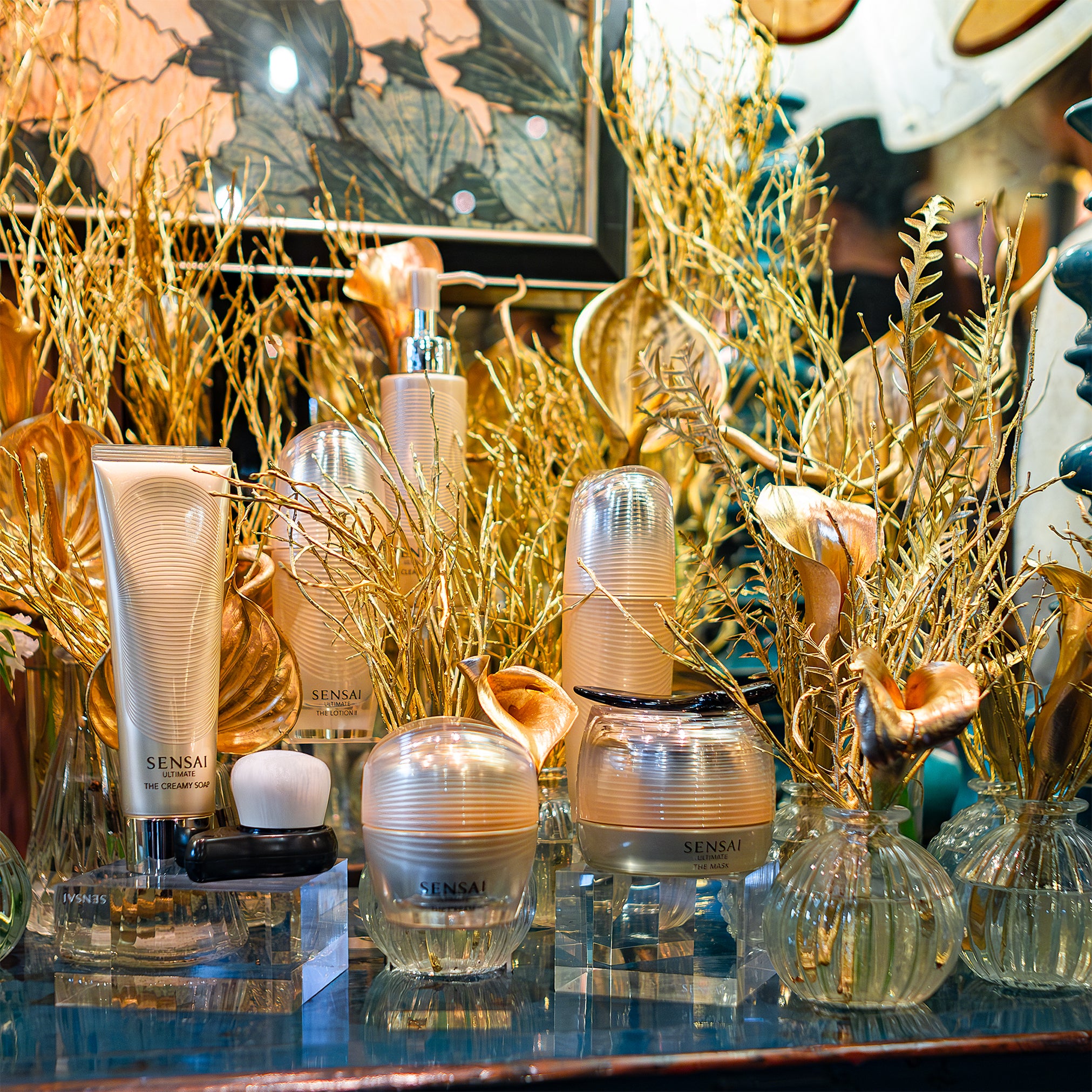 Gold floral arrangements by Amarante London, highlight the sophistication and luxury of Sensai skincare products elegantly displayed during the product launch event in London at Beaverbrook Town House.