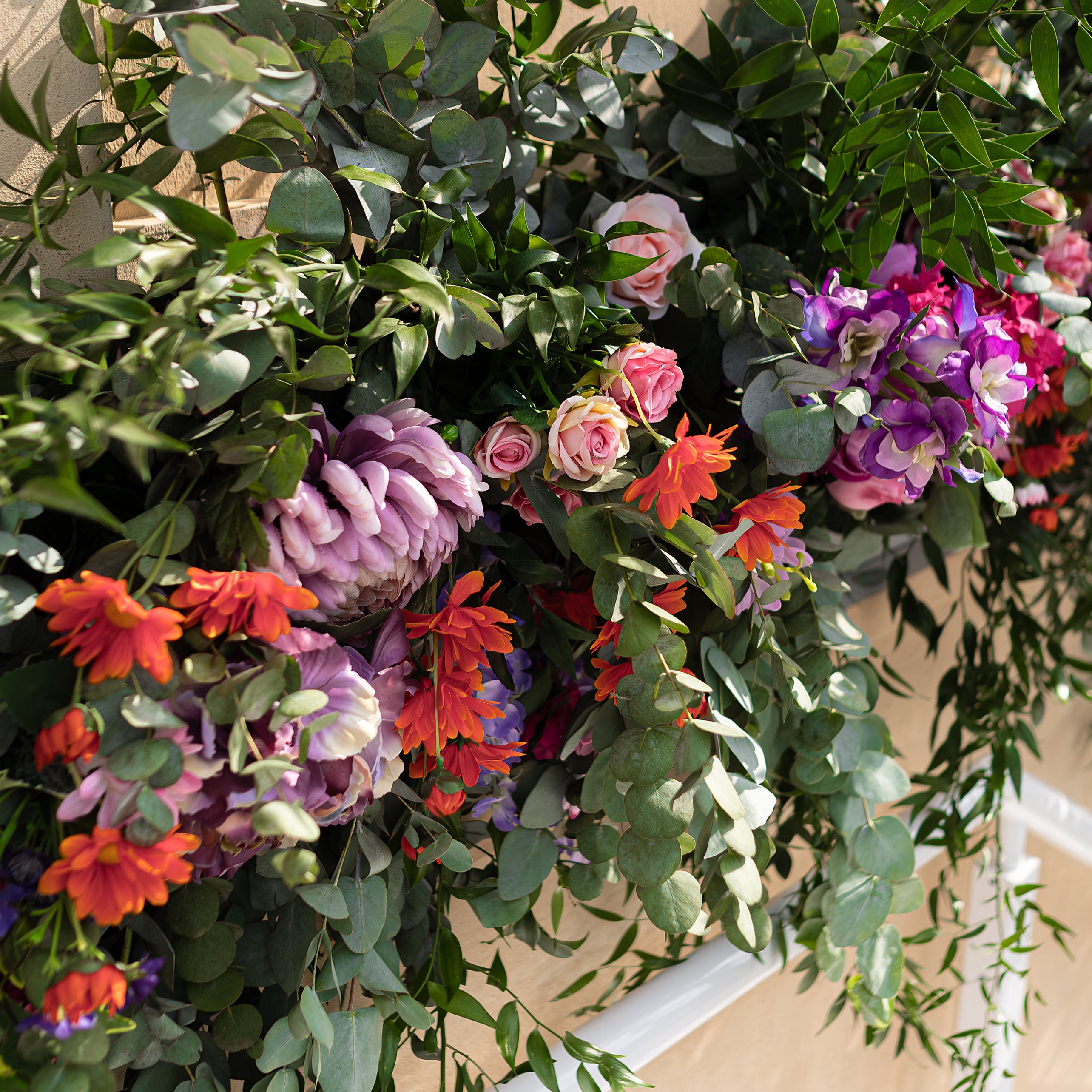 This is a close-up view of a vibrant floral arrangement designed for the Angelo Poretti stand. It features pink roses, purple hydrangeas, and orange gerberas intertwined with lush green foliage. Designed by Amaranté London, this installation at Regent’s Park for the Taste Festival event showcases our expertise in creating stunning floral decor for events.