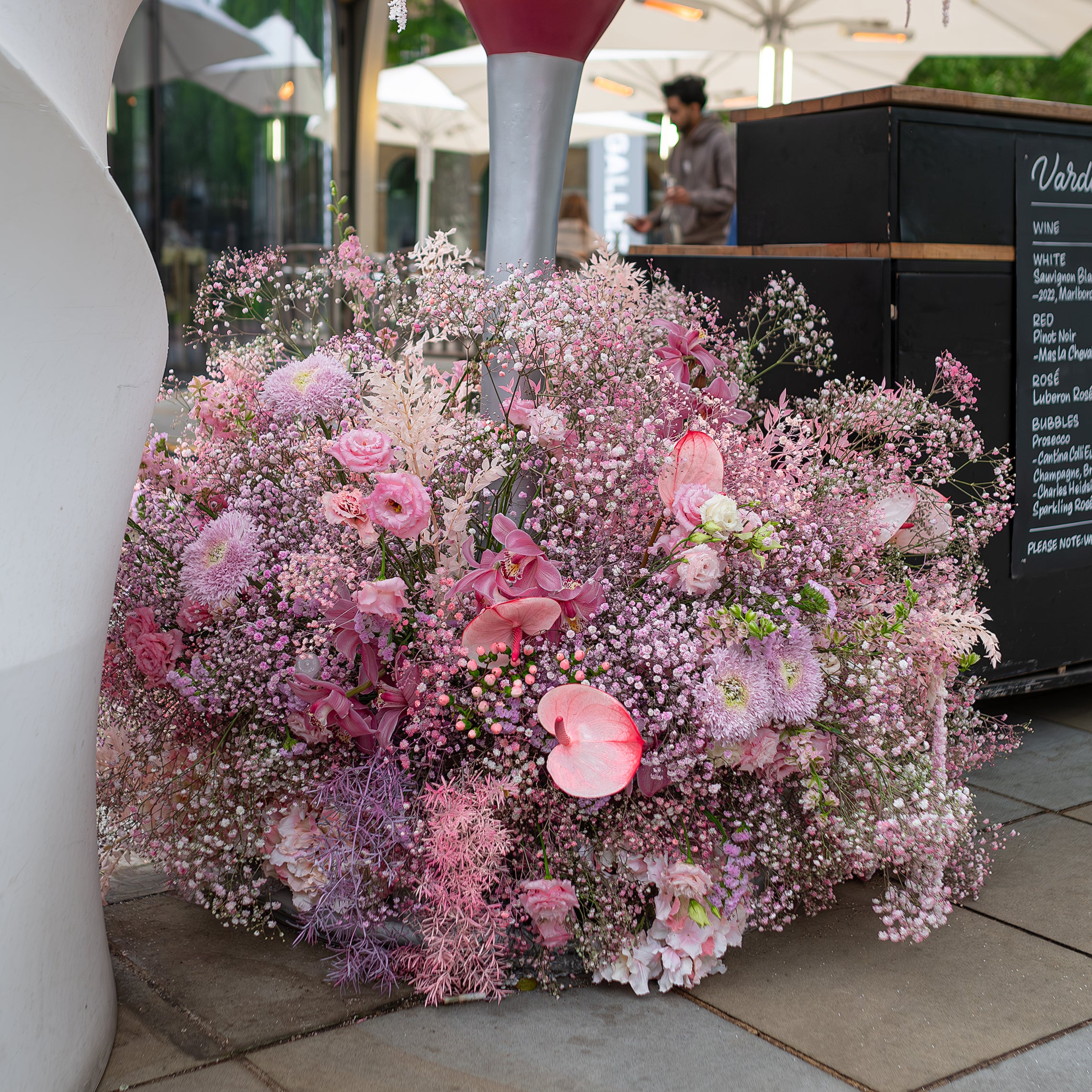 An extravagant pink and white floral display outside Vardo restaurant, combining roses, hydrangeas, and lush foliage, designed and created for Chelsea in Bloom's theme of Floral Feasts by Event Florist Amaranté London - Flower arrangements for high-profile store launches and fashion events.