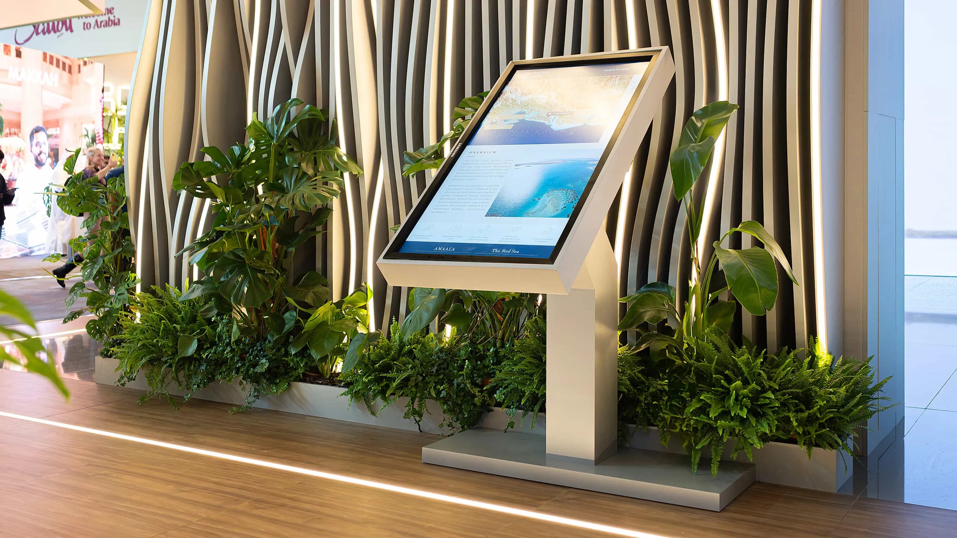Amaranté London enhanced this WTM presentation area with lush greenery surrounding an interactive display, merging technology with nature.