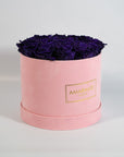 Luxurious dark purple Roses imbedded in a magical pink box 