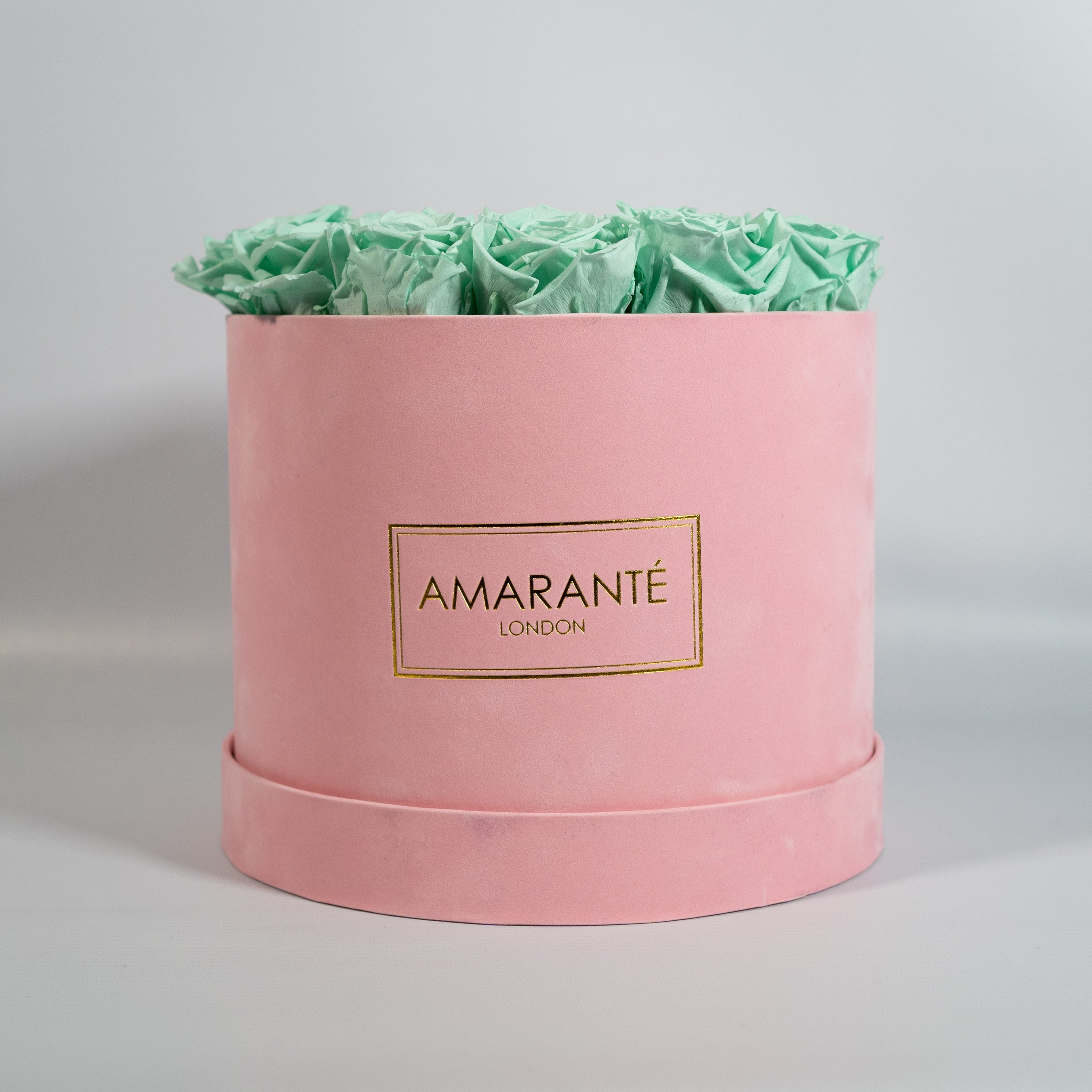 Revitalising mint green Roses featured in a delicate pink box 